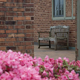 Photo of a bench and flowers. Link to Bill and Susan Sack's story.